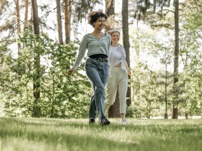 Young, happy couple walking together in the park on a sunny day.