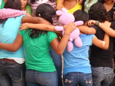 Residents of Covenant House Honduras in the embrace of a group hug.