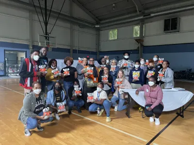 Covenant House Georgia and CHI staff pose with comfort koalas in a gymnasium at the close of a YMHFA course in 2022. The koala is a nod to Australia, where YMHFA originated.