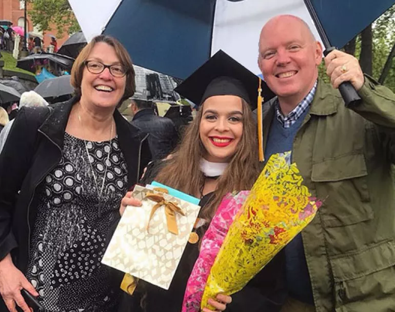 Nancy Downing, former Executive Director of Covenant House New York, and Kevin Ryan with CB, a Covenant House alum, at her college graduation