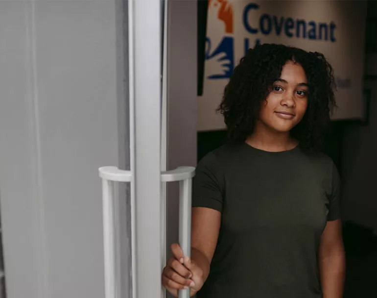 youth opening door to Covenant House Maryland site