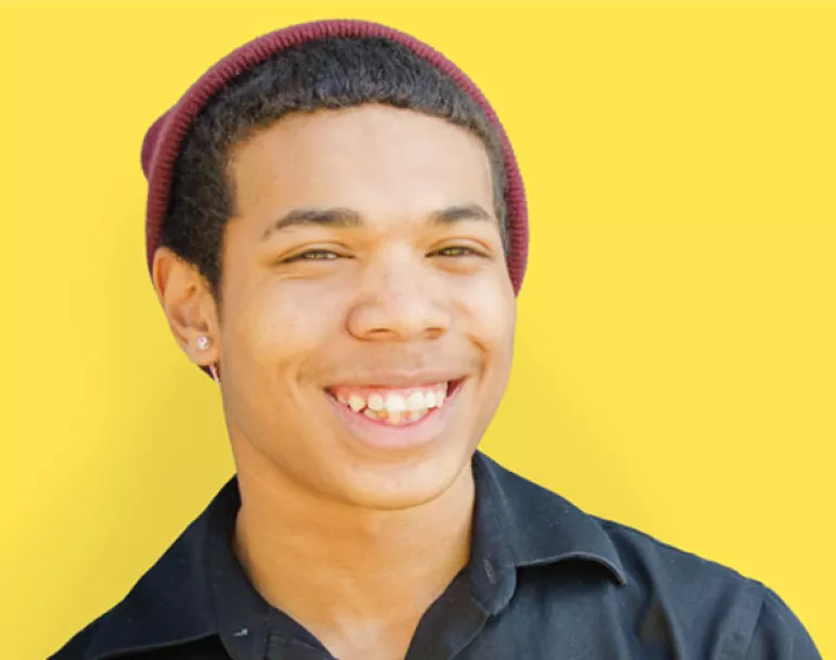 smiling youth wearing a beanie | Covenant House