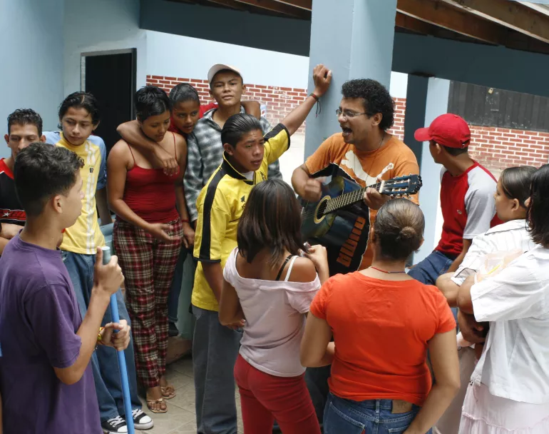 latin american youth enjoying music in Covenant House shelter | Foster Care Reform