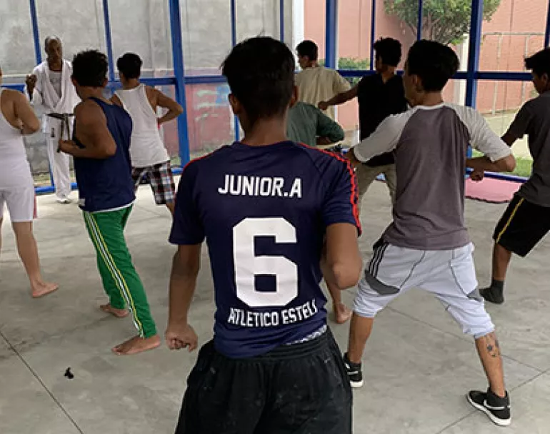 Youth playing basketball at Covenant House Latin America