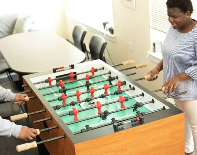 former homeless youth playing foosball | Covenant House - Philadelphia, Pennsylvania | homeless shelters in philadelphia