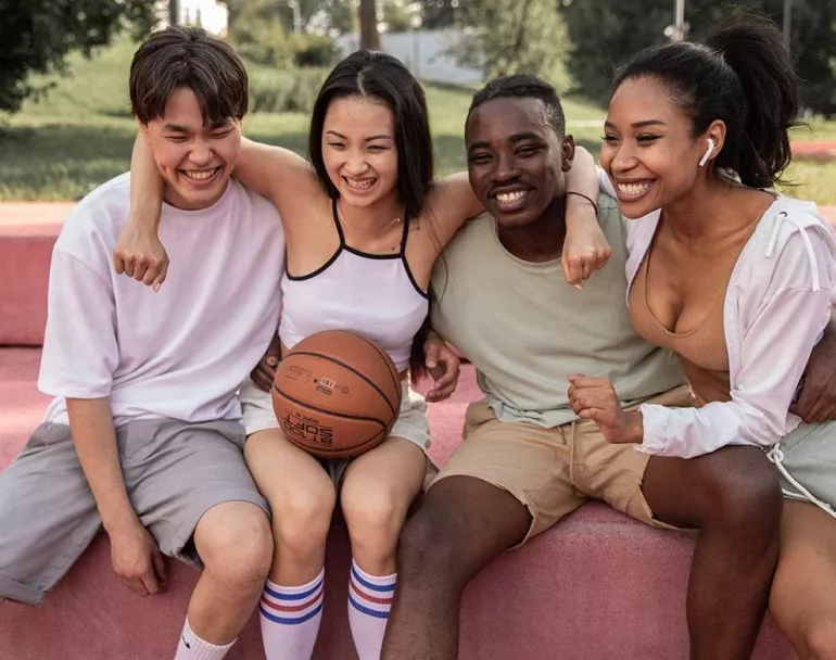Happy group of previously homeless teens with basketball | Covenant House - Financials