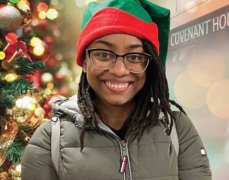 homeless youth next to shelter and Christmas tree | Covenant House