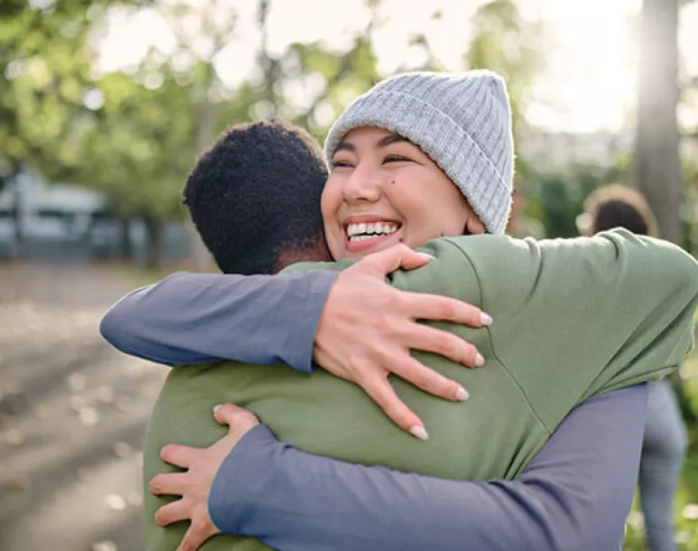 Former homeless teens hugging and happy