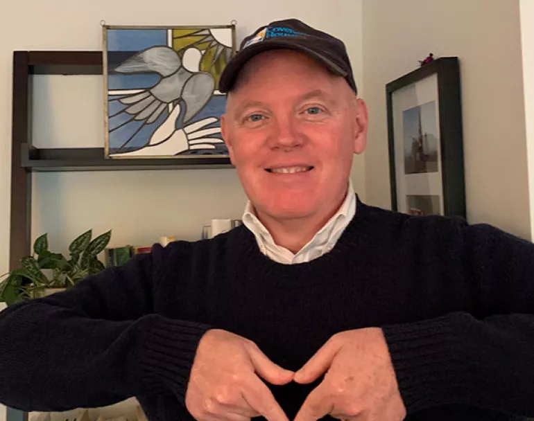 Former Covenant House CEO Kevin Ryan forming a heart with hands 