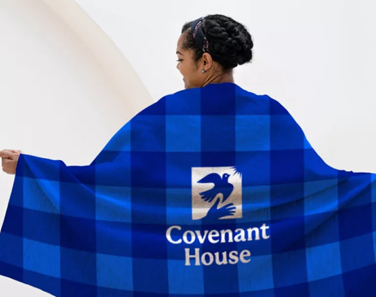 Former homeless teen wrapped in premium Covenant House blanket | Donate Now