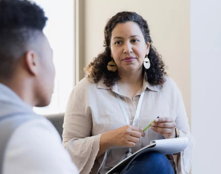 Previously homeless youth receiving mental health help from professional | Covenant House - Donate Now