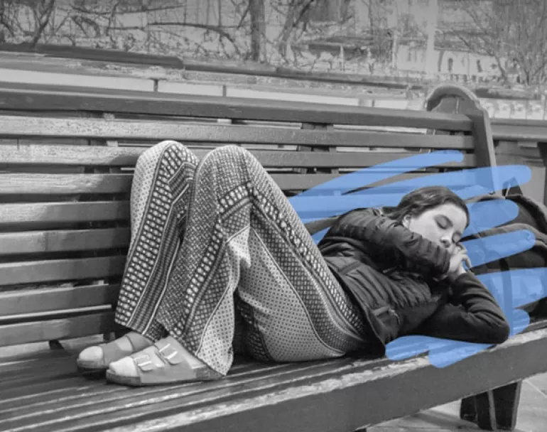homeless youth sleeping on outdoor bench | Covenant House - Donate Today