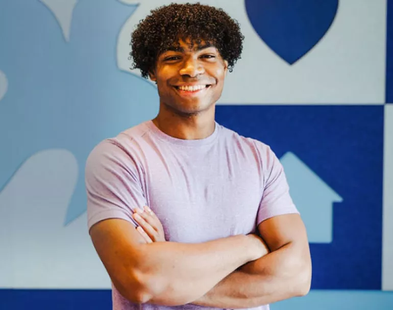 former homeless teen smiling at Covenant House | Donate today