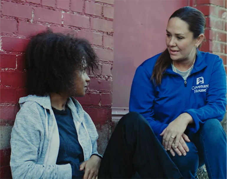 Covenant House outreach staff and homeless youth outside