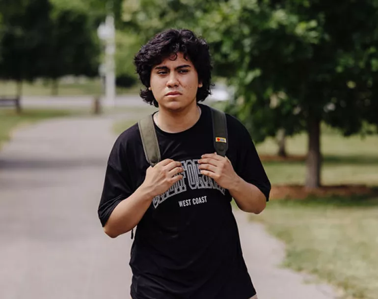 Alone and homeless teen with backpack outside | Covenant House - Donate today to support homeless kids 