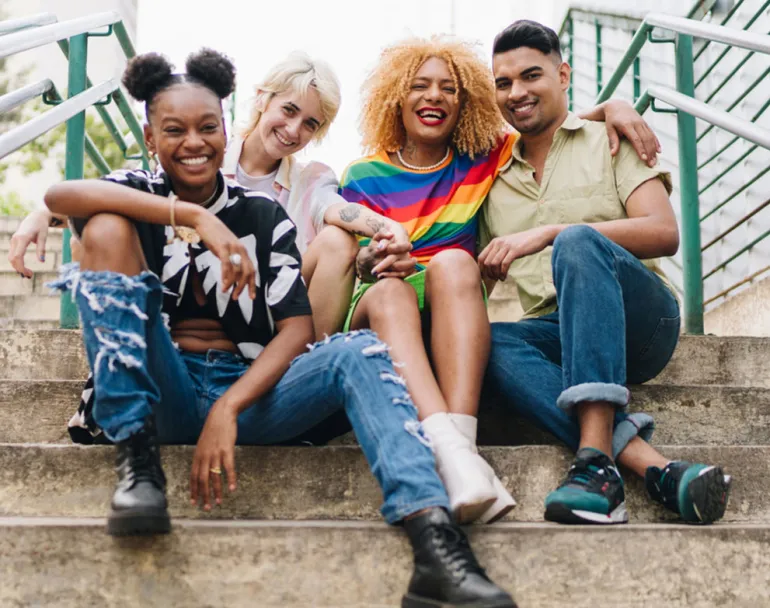 LGBTQ+ youth group sitting on staircase | Covenant House - Join Strides for Pride