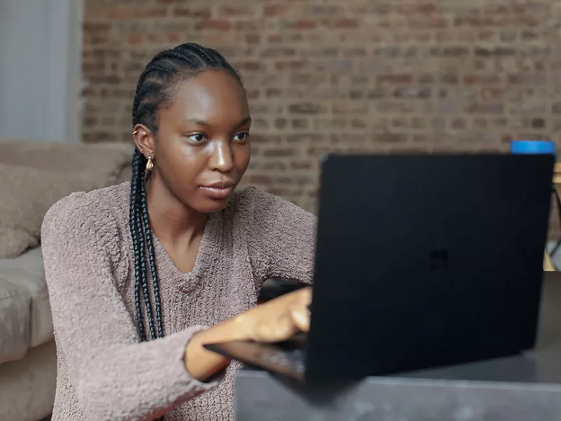 Former homeless young woman using laptop