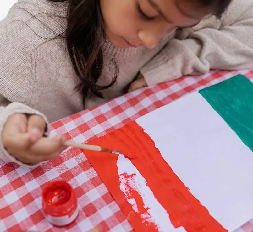 young girl painting Mexican flag | Covenant House - Latin America Residential Care