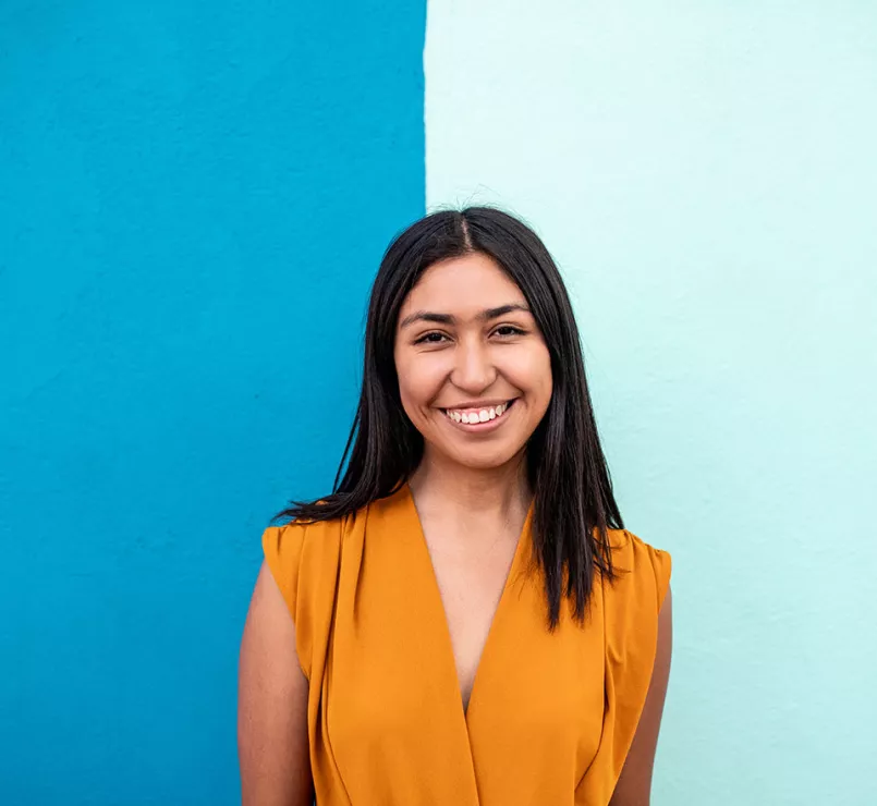 happy youth in front of two shaded blue wall | Covenant House - Get Involved