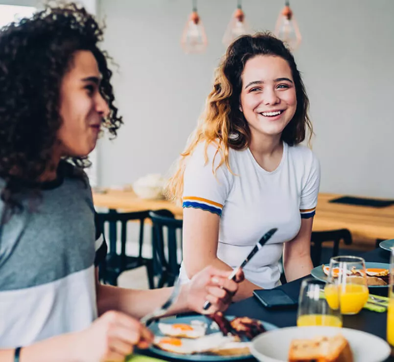 Homeless girls eating breakfast together at a Covenant House location