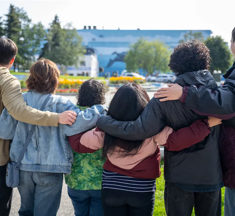 homeless youth huddled together outside | Covenant House
